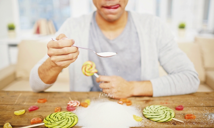 Guy eating sugar with spoon